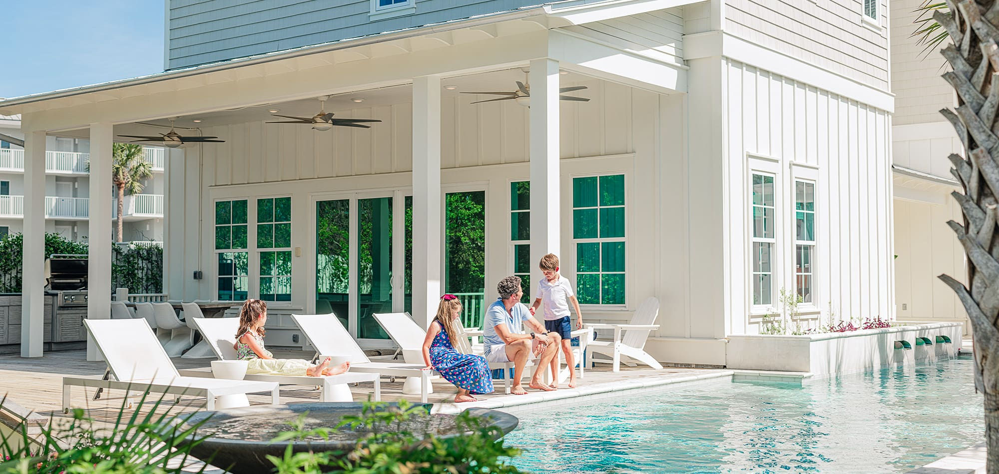 Family hanging out around the pool at a 360 Blue Property