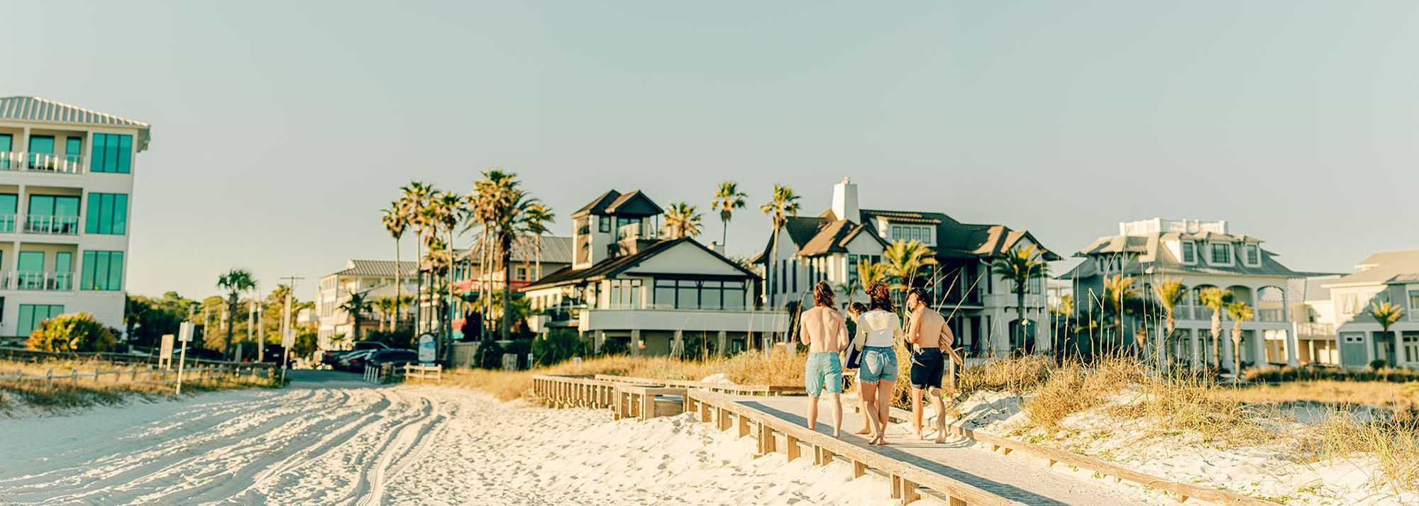 Friends walking back from the beach to their vacation home on the Emerald Coast